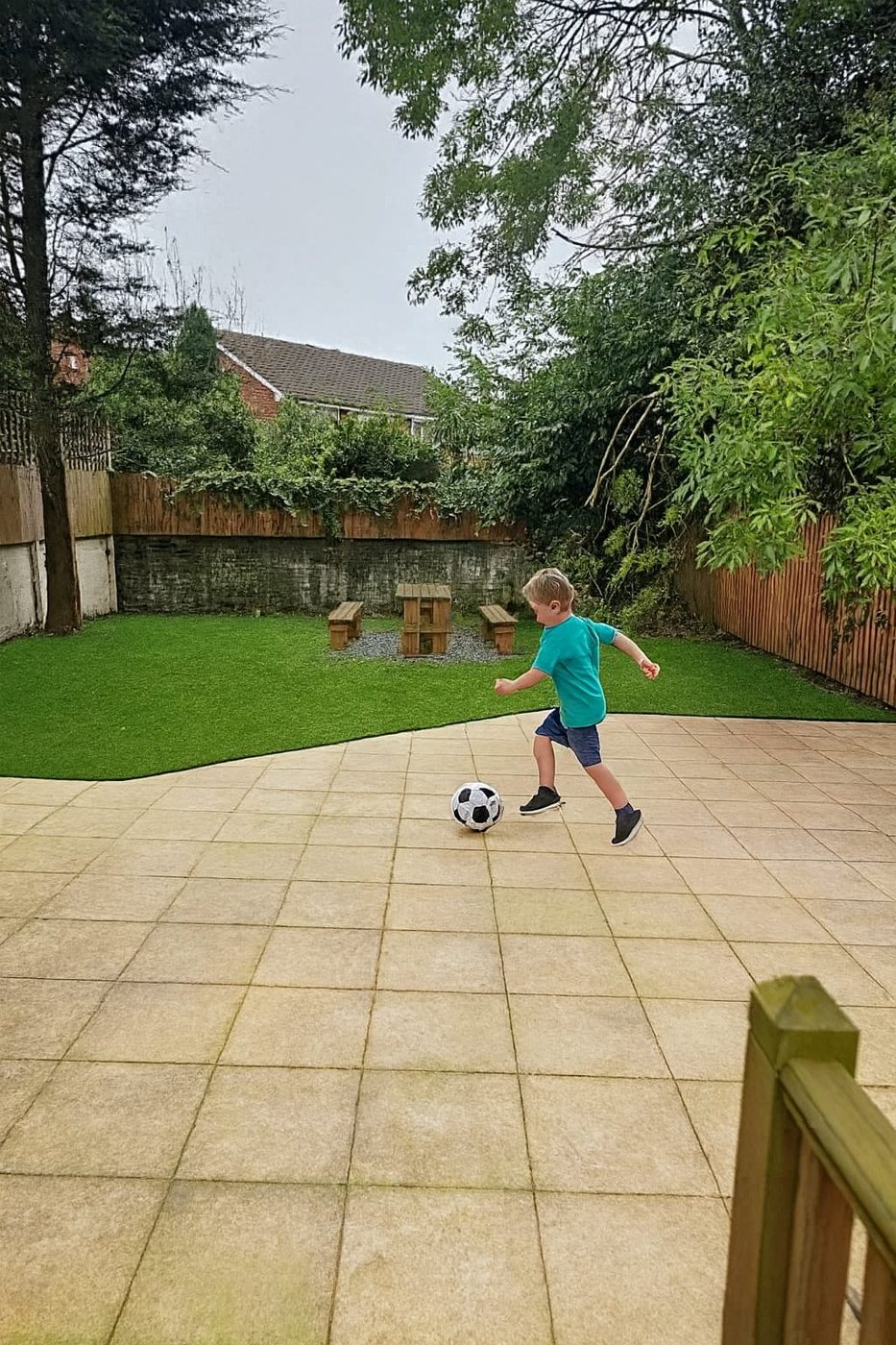 The secure rear garden, with lawn, patio and boundary fencing