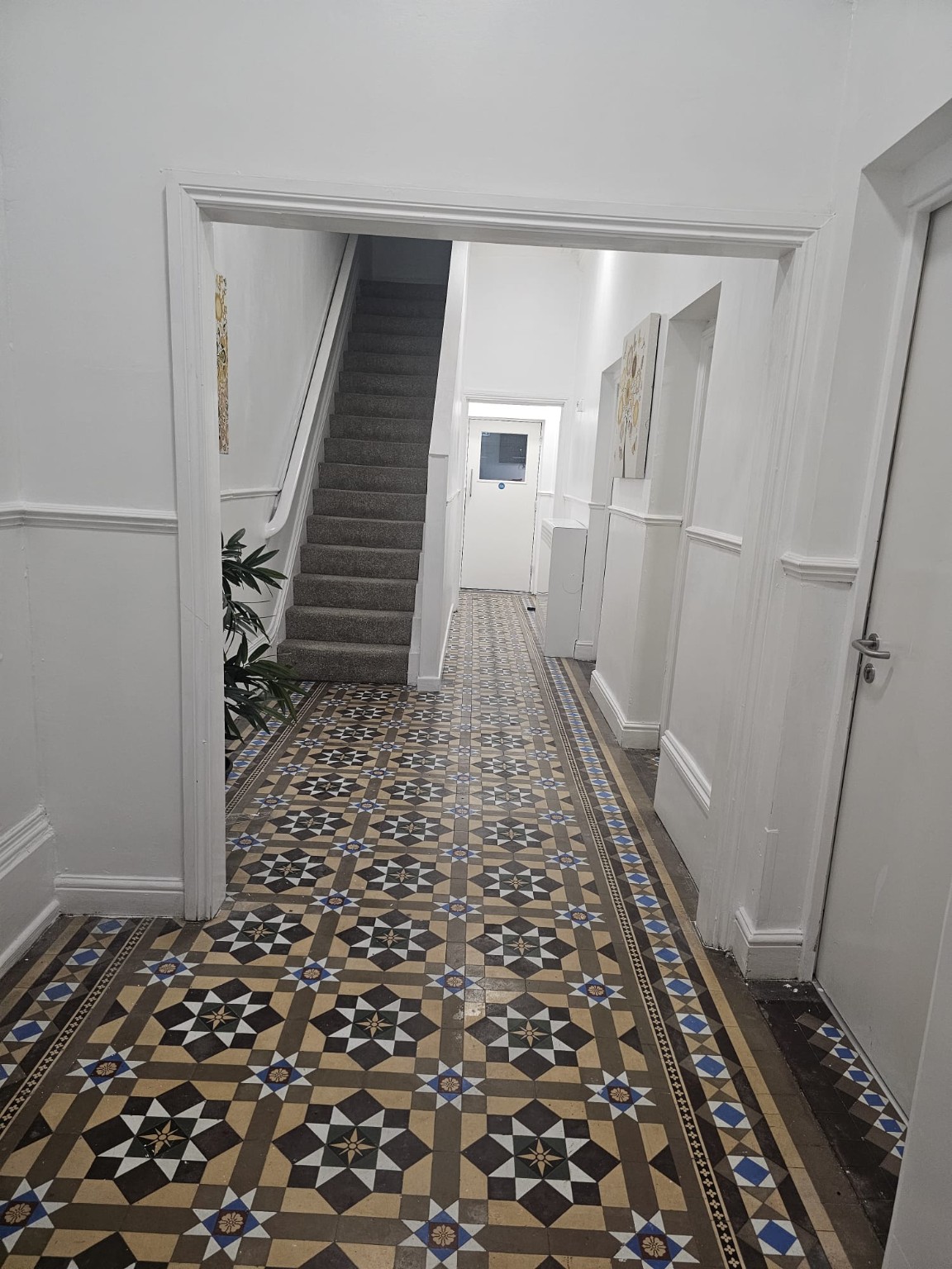 The entrance hallway at Jubilee House, with its original patterned tiled floor