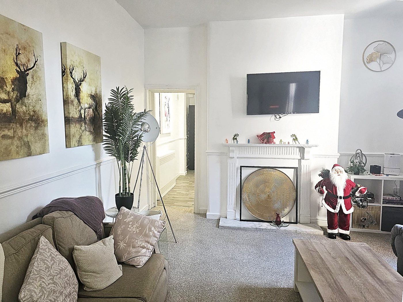 The second living room, with sofas and a feature fireplace